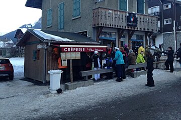 a crepe hut with a queue outside