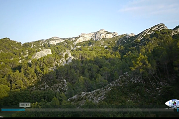 A screen shows a video of a mountain with the time of 00:12