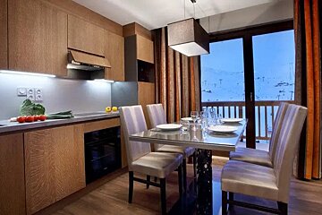 A kitchen with a dining table and chairs and a sliding glass door