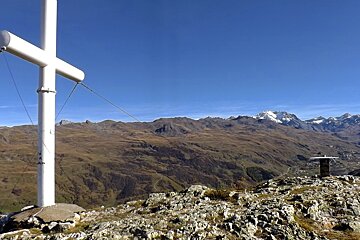 a white cross on a mountain top above st martin