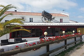 a restaurant with a wagon cart on the roof