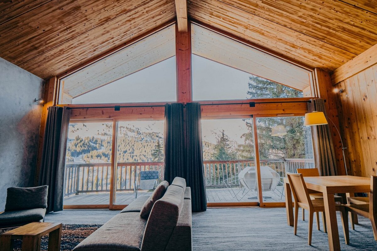 A living room with a couch and a table and chairs