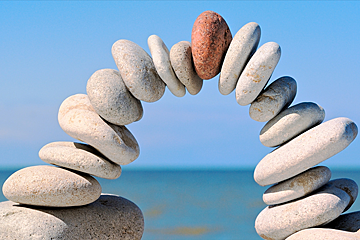 A stack of rocks with a red rock in the middle