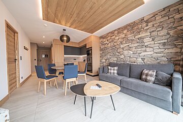 A living room with a stone wall and a couch