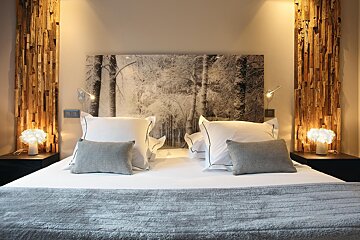 A bed with a picture of trees on the headboard