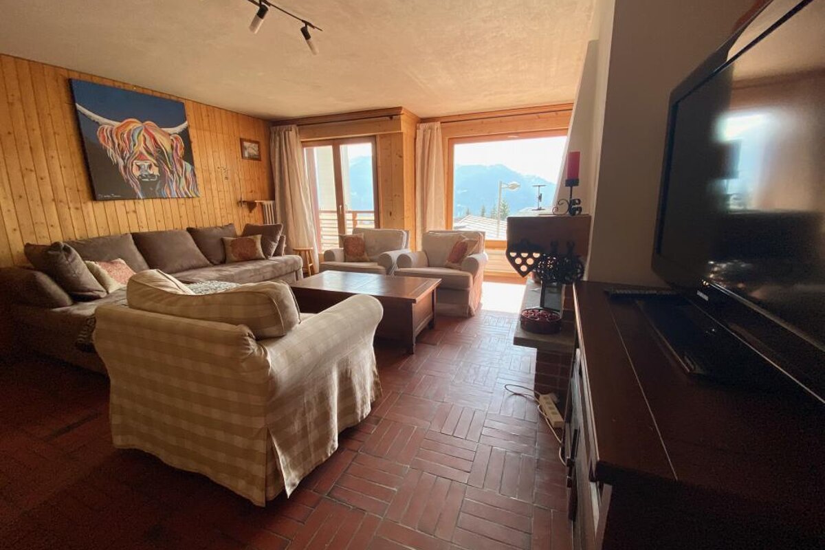 A living room with a painting of a highland cow on the wall