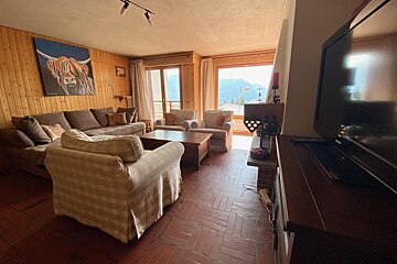 A living room with a painting of a highland cow on the wall