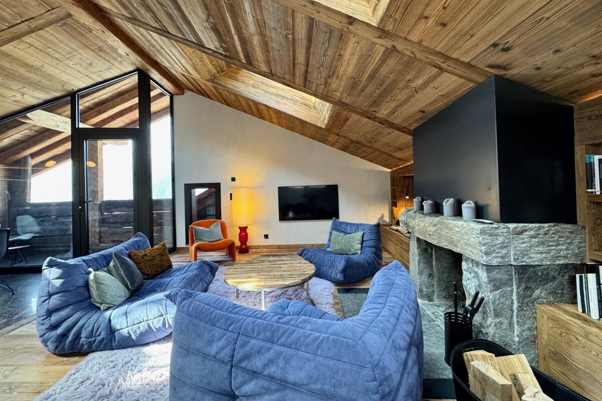 A living room with blue furniture and a fireplace