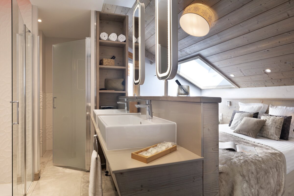 A bathroom with a sink and two mirrors