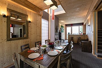 A dining room table with plates and utensils on it