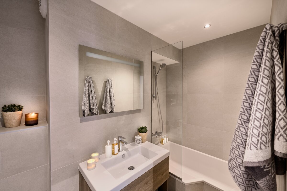 A bathroom with a sink a bathtub and a mirror