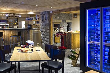 A room with a table and chairs and a helmet that says poc on it