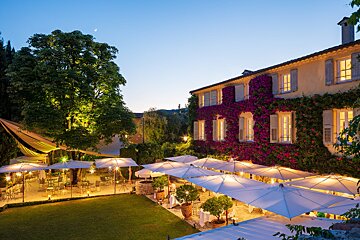 A large building with purple flowers on the side of it