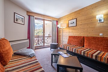 A living room with a couch and two tables