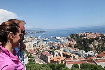 A man and a woman are looking out over a city