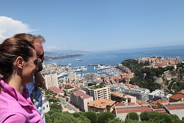 A man and a woman are looking out over a city