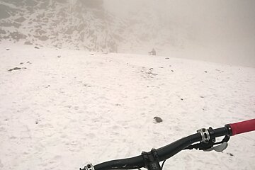 mountain bikers in the cloud & snow