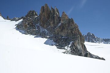 a rock outcrop surrounded by snow