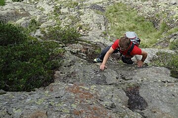 a man climbing some boulders in chamonix
