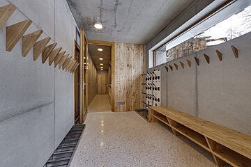 A hallway with a bunch of hooks on the wall