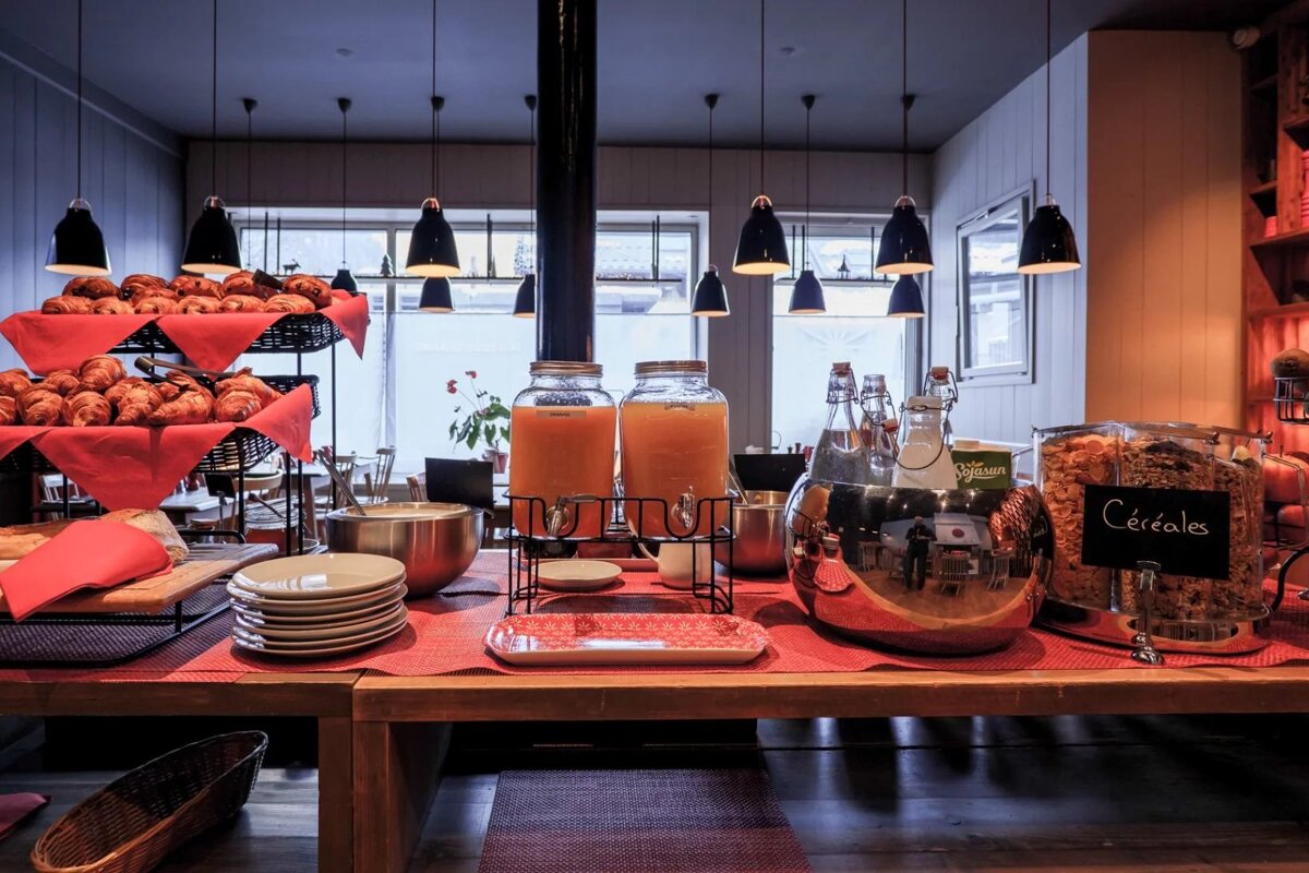 A buffet table with a jar of cereal on it