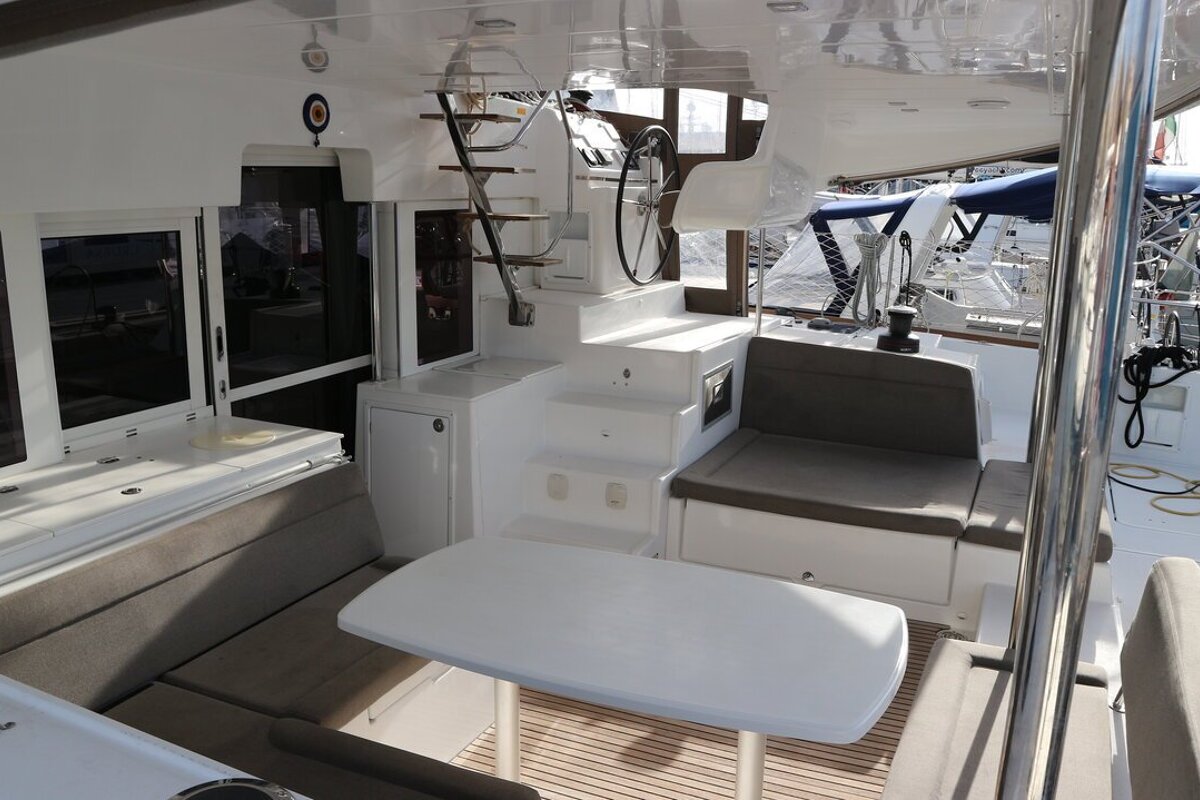 The inside of a boat with a table and stairs