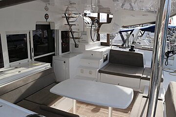 The inside of a boat with a table and stairs