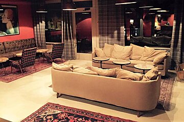 a comfy looking lounge bar with vintage furnituire