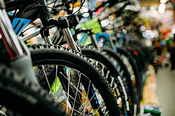 A row of bicycles are lined up in a store