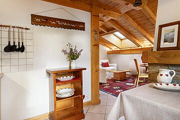 A wooden shelf with plates and bowls on it