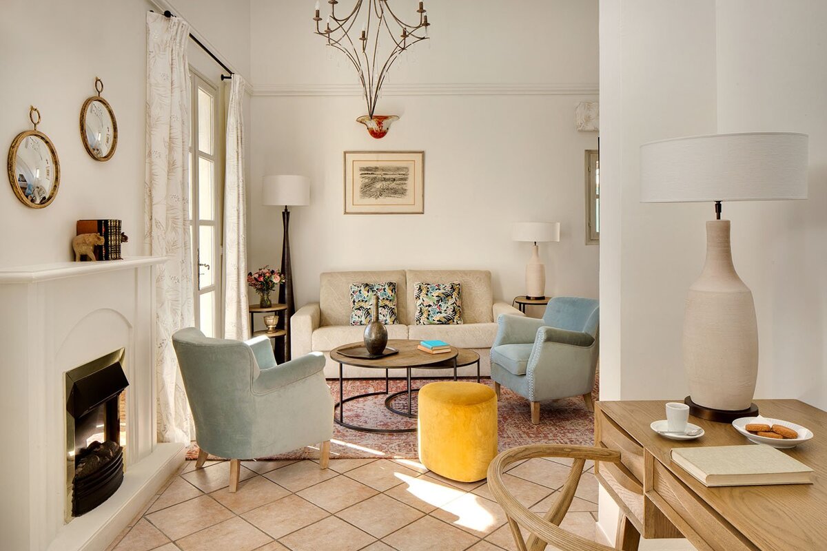 A living room with a couch and chairs and a fireplace