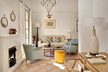 A living room with a couch and chairs and a fireplace
