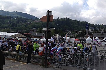 a group of road bikers at the start line of a race