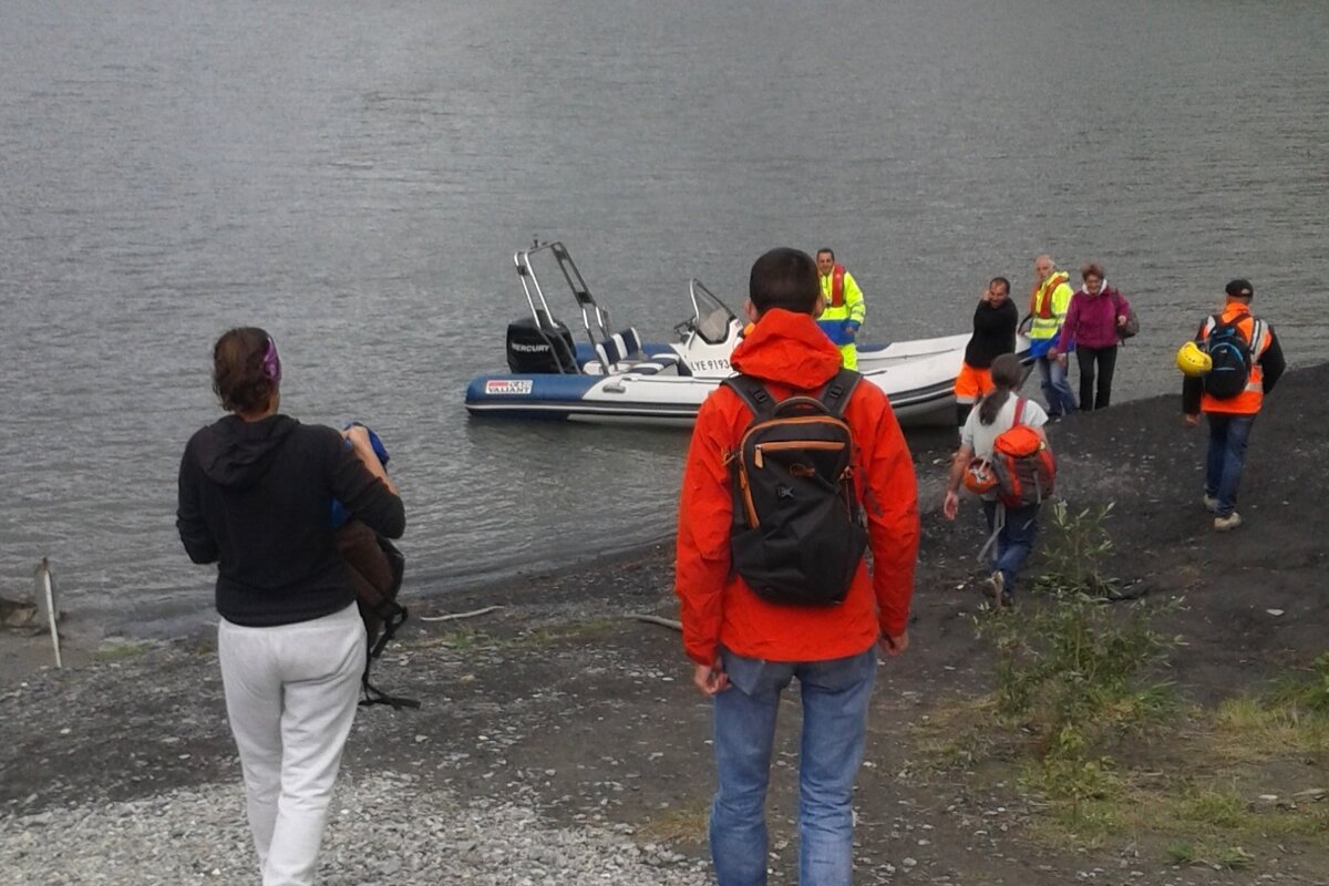 people waiting to board a small boat