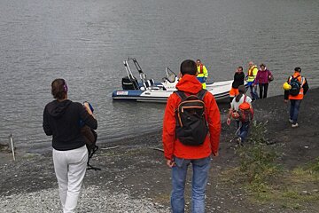 people waiting to board a small boat