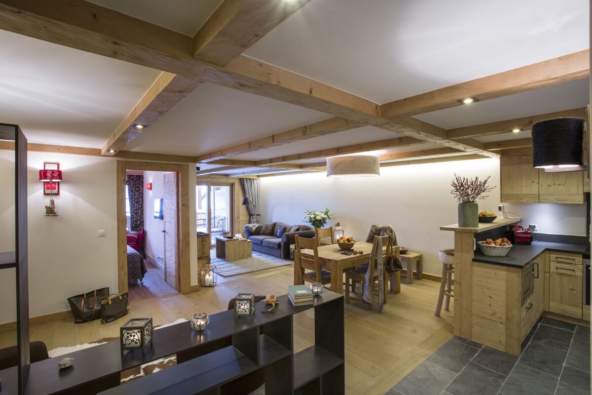 A living room with a dining table and chairs