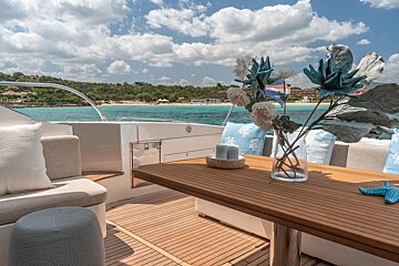 A wooden table with a vase of flowers on it