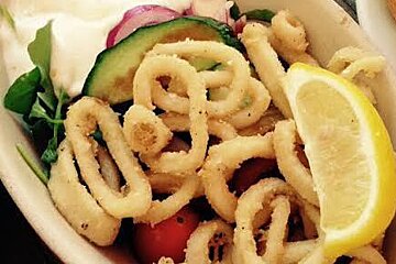 a plate of calamari with lemon