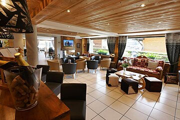 A bottle of champagne sits on a table in a living room