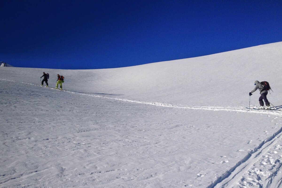 A group of people skiing down a snowy hill