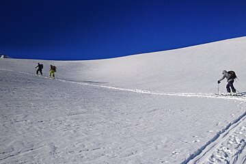 A group of people skiing down a snowy hill
