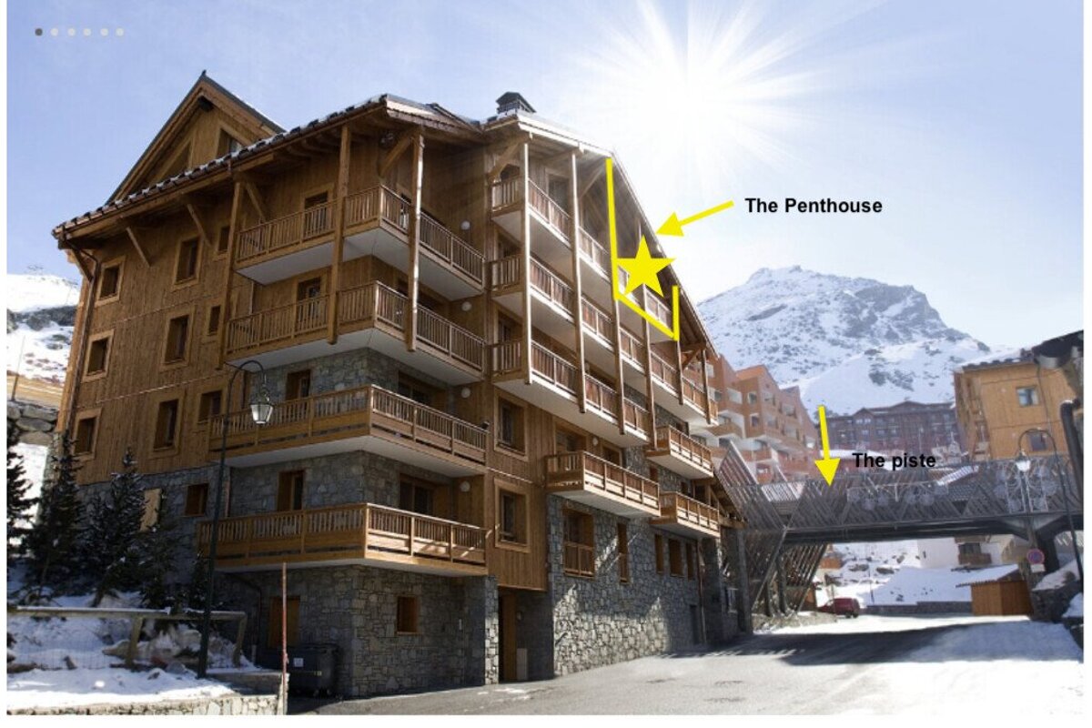 A building with a yellow arrow pointing to the penthouse