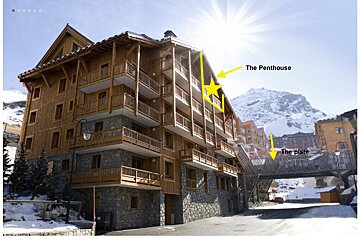 A building with a yellow arrow pointing to the penthouse