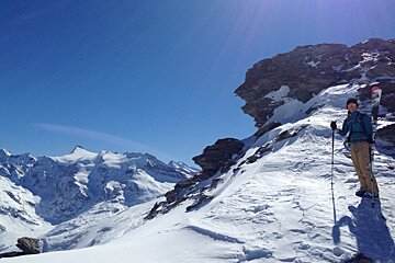 a skier stood at the top of a ridge