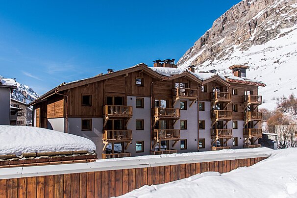A snowy building with a mountain in the background