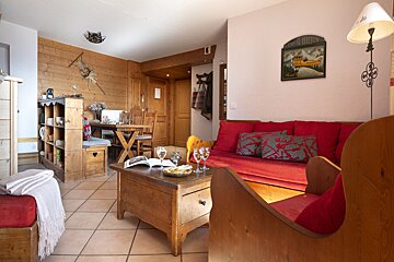 A living room with a red couch and a sign that says camping & refuge