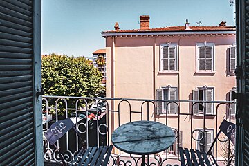 A balcony with a table and chairs and a sign that says 333