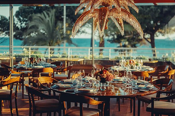A restaurant with a palm tree hanging from the ceiling