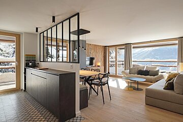 A living room with a couch a table and chairs