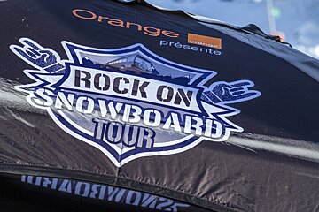 A black and white sign that says rock on snowboard tour